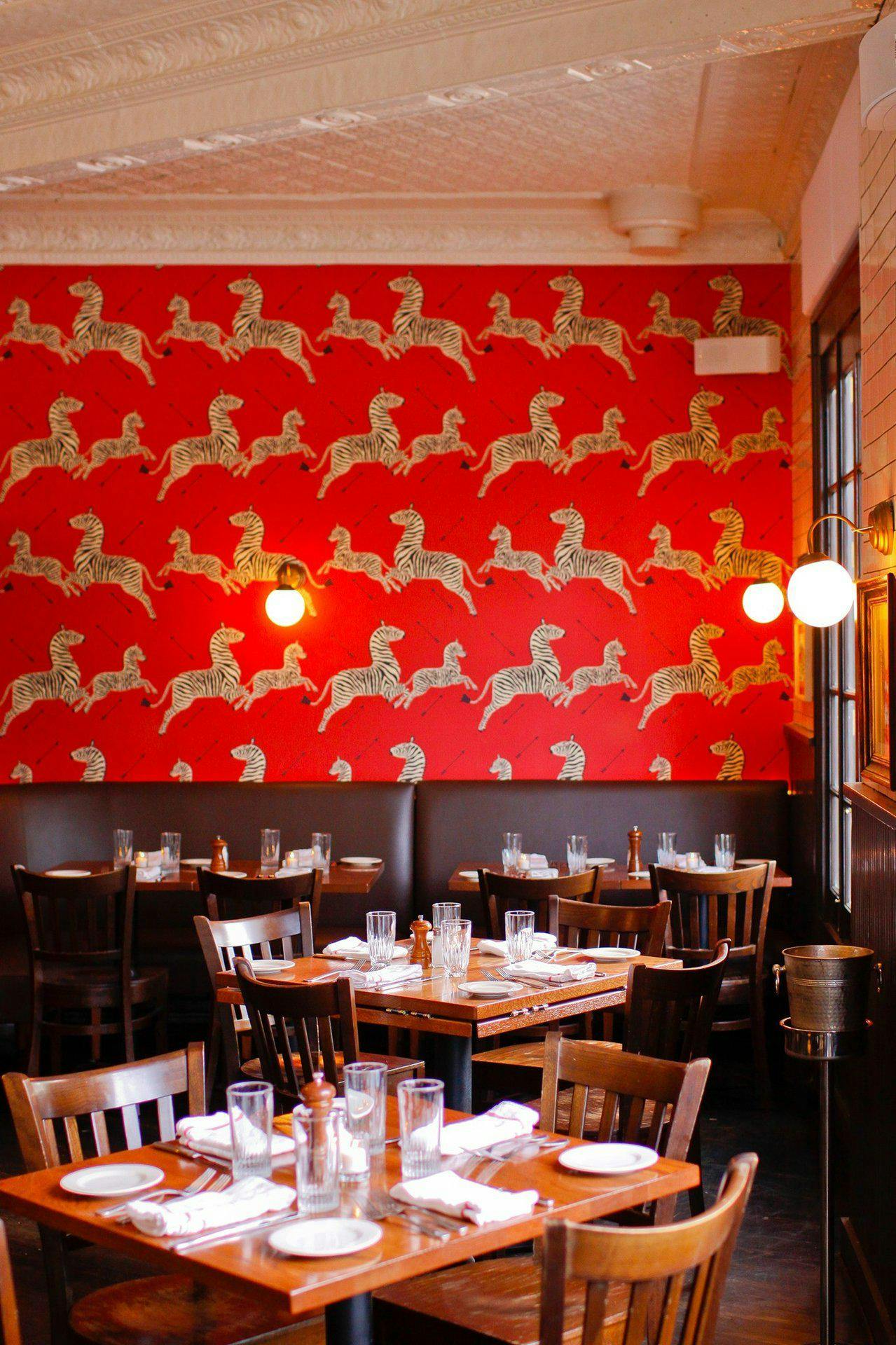 Interior shot of Almond Restaurant in Bridgehampton, NY with red wall