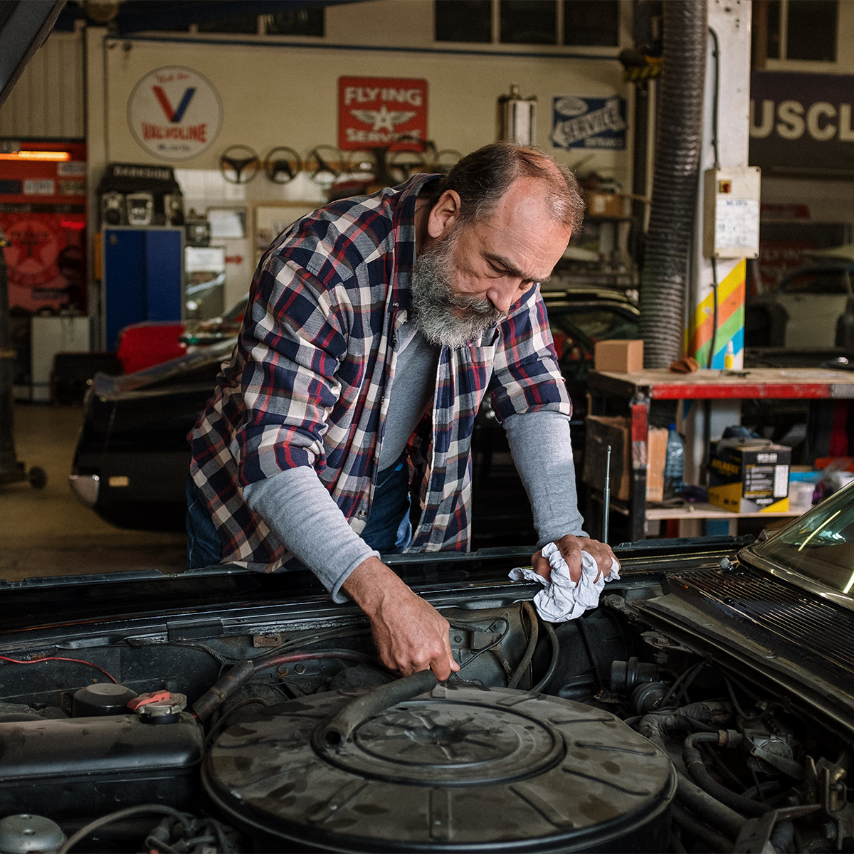 Hampton Auto Garage owner repairing a vintage car in his garage