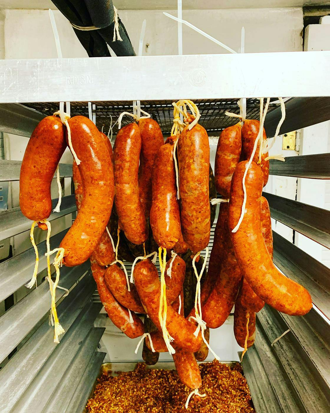 Almond in Bridgehampton, NY - Hanging sausages made in-house